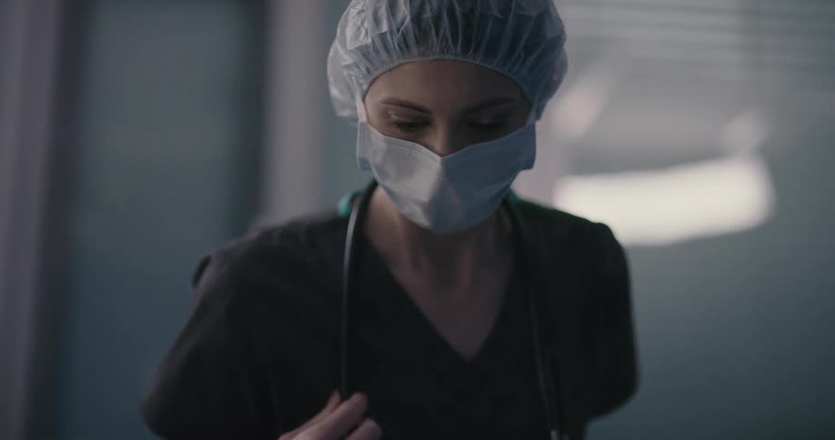 A medical person looks down at something