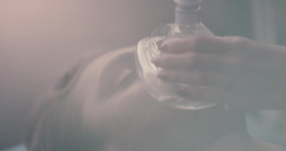 A person puts an oxygen mask on someone