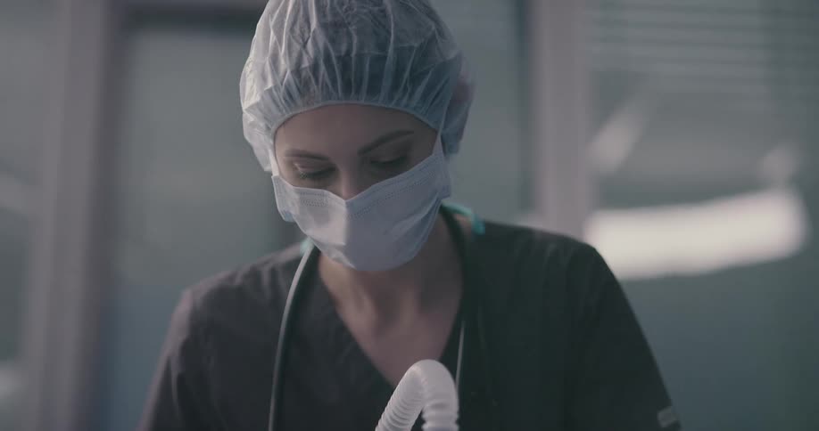 Nurse places mask on patients face
