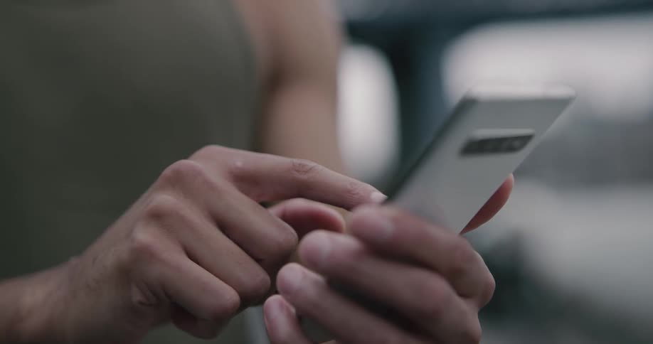 A person taps on their phone
