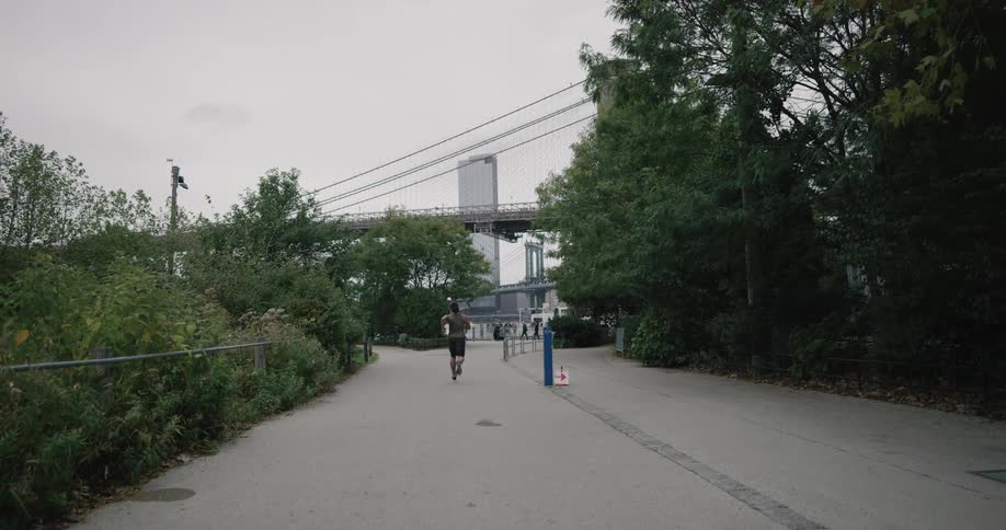 A man is jogging outdoors during the day