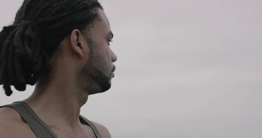 A man breathes deeply and stares at something off screen