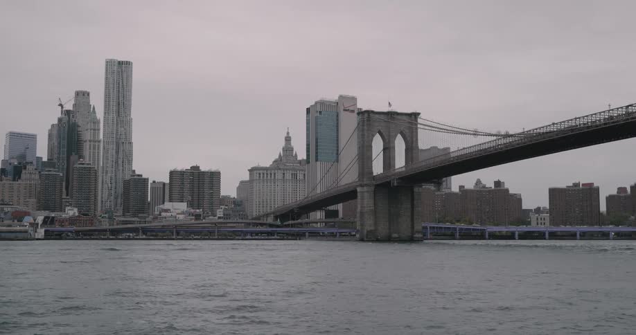 A bridge spans a river near a large city