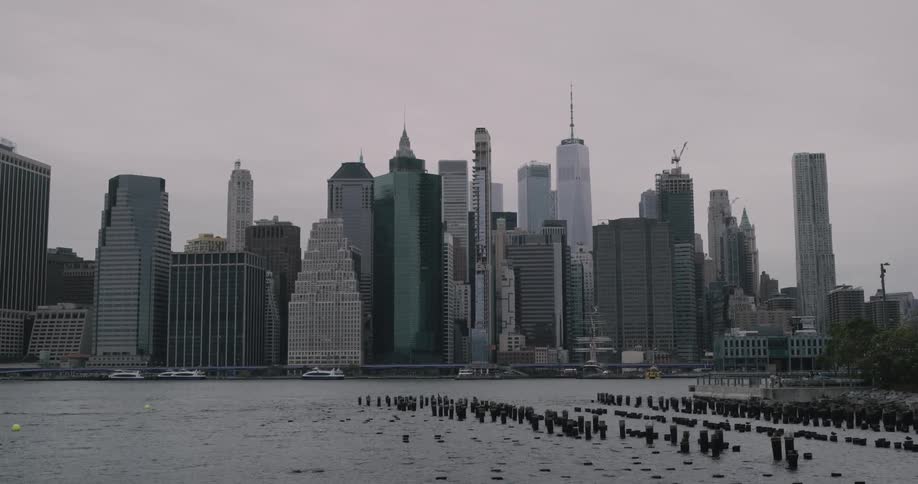 The tall city buildings sit next to the river