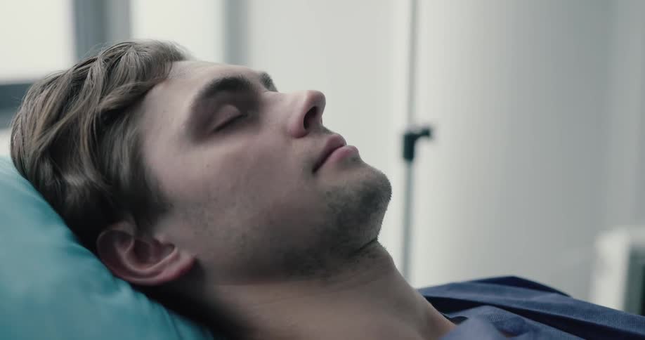 An unconscious man sleeping at the hospital
