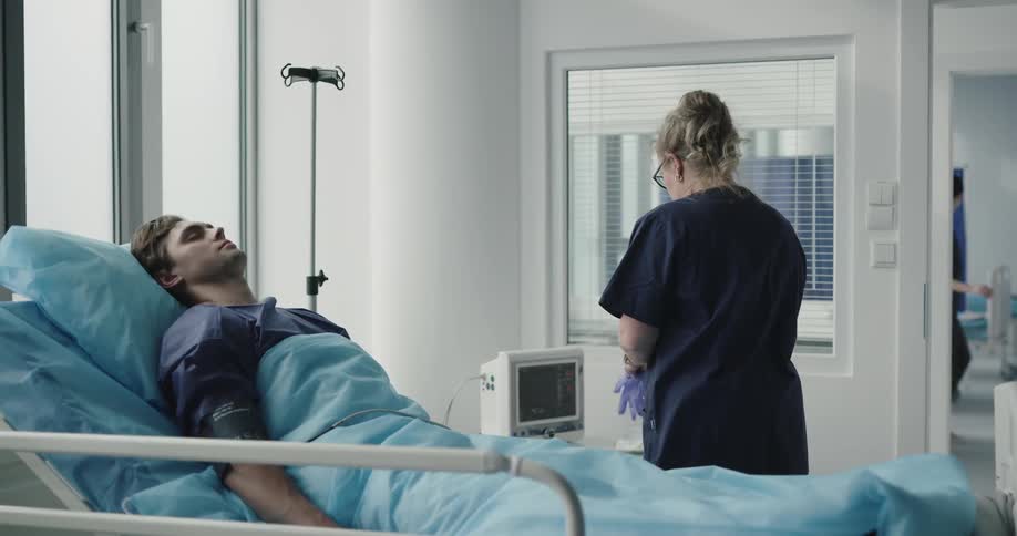 Female nurse preparing something for the male patient
