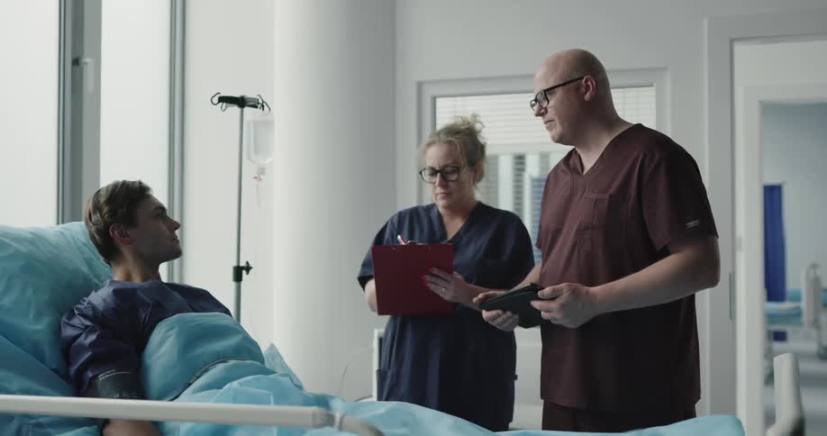 A doctor talking to a patient with a nurse