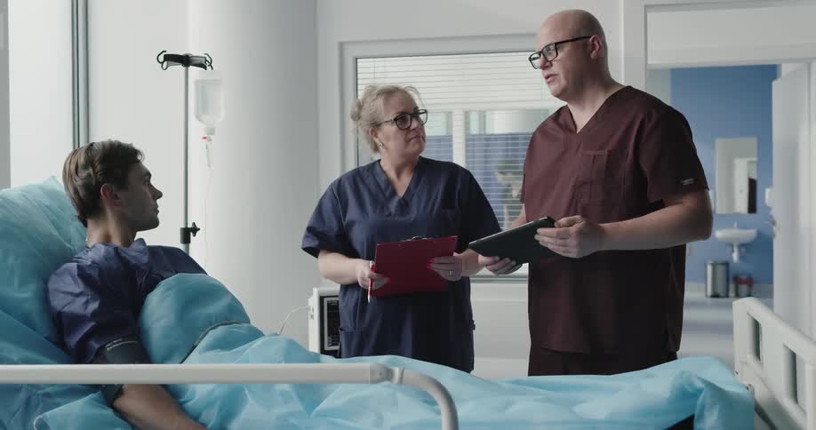 Doctors checking patient at hospital room