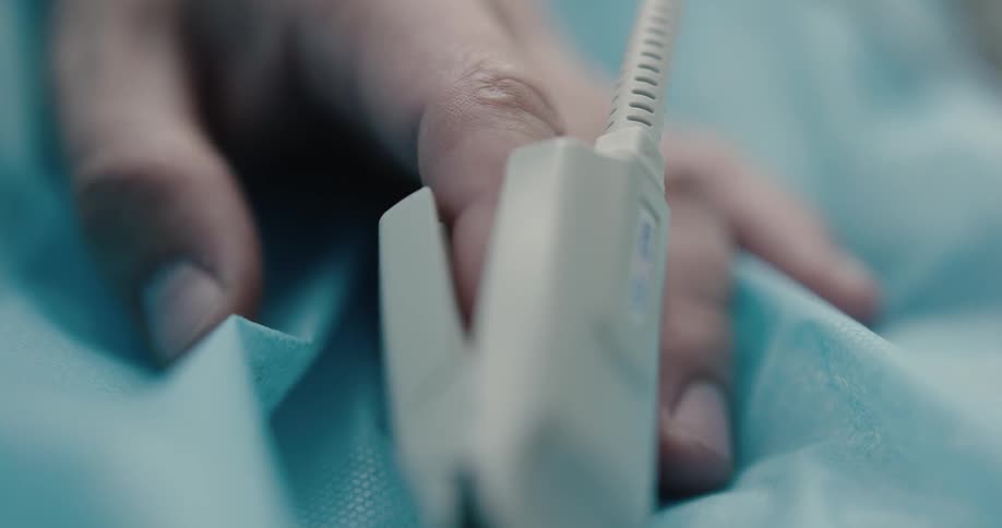 A person is lying in a hospital bed