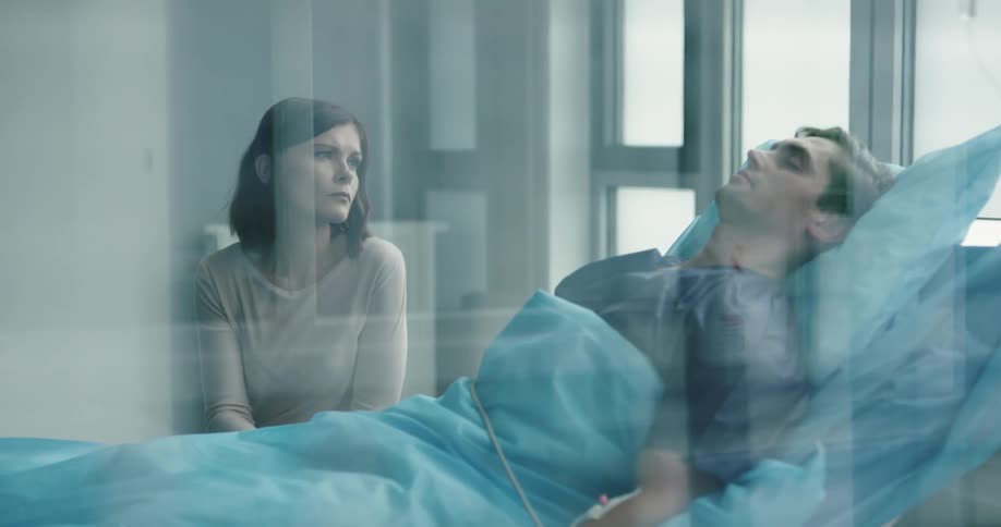 A woman is visiting a man in the hospital