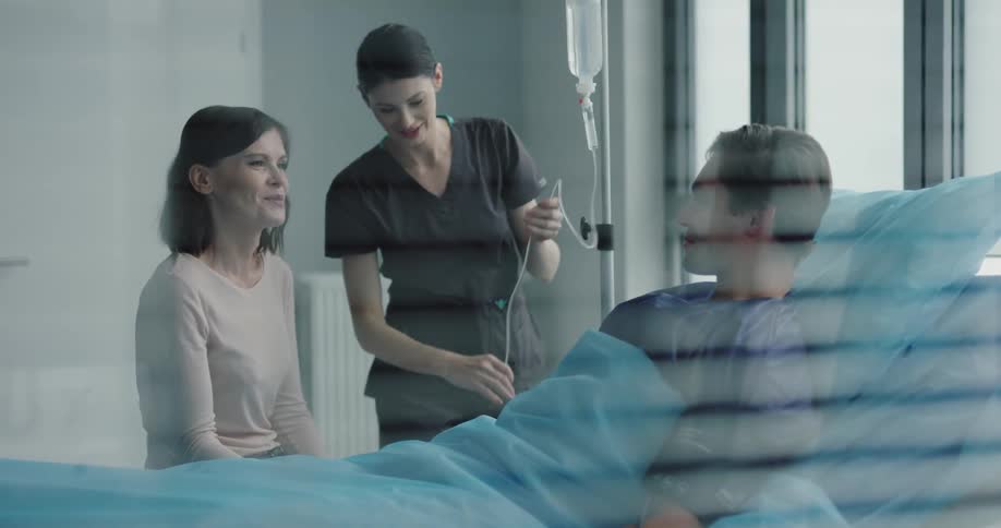 A nurse checking her patient condition at the hospital room
