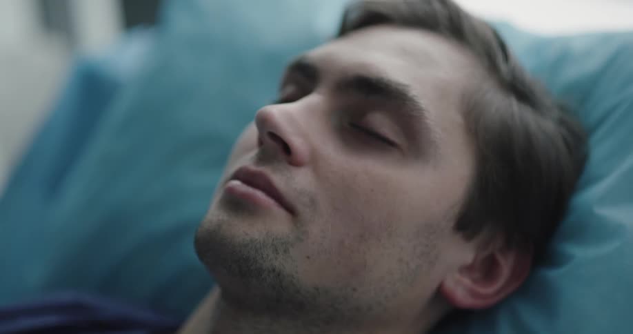 An unconscious man sleep on the pillow