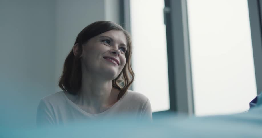 A woman is smiling indoors