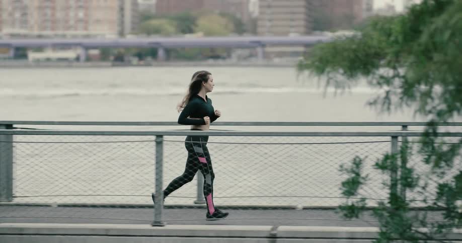 A woman is jogging outdoors