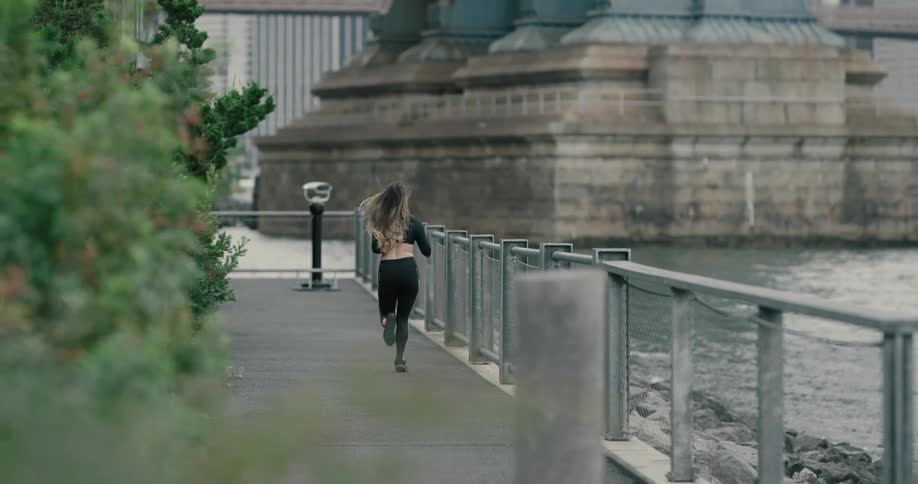 A woman runs along the waterfront