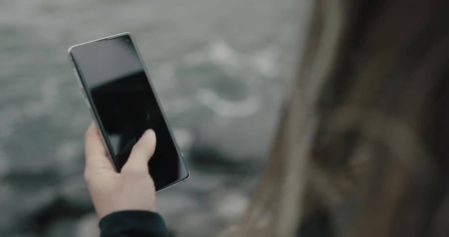 A woman is using her phone outside