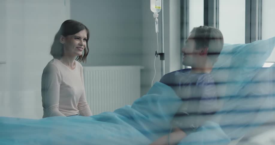 Female talking and laughing with a male patient at the hospital