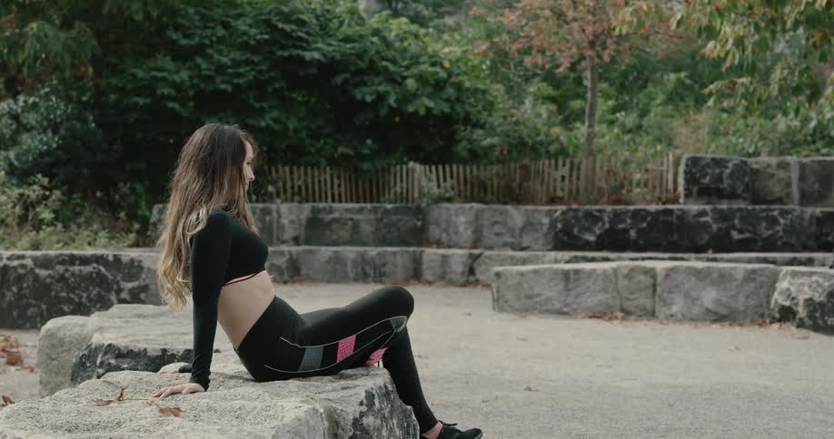 Woman sitting on a rock at the park