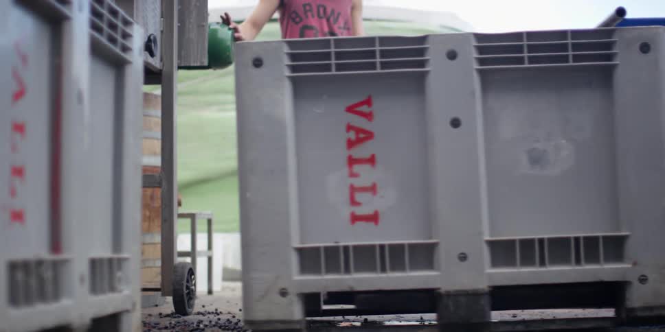 A man stands by as a forklift is operated
