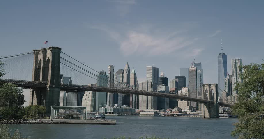 Skyline of the city and bridge over which vehicles go during daylight