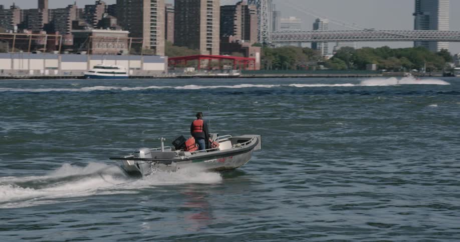 A man is driving a boat in the lake