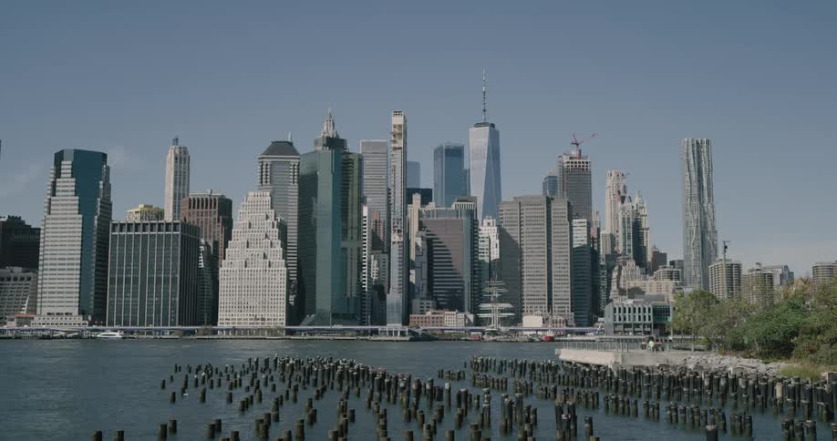 An urban skyline can be seen across a body of water