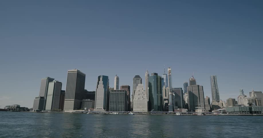 A scenery of a city skyline on the day from the lake