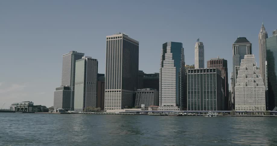 Skyscrapers and buildings next to a highway and body of water
