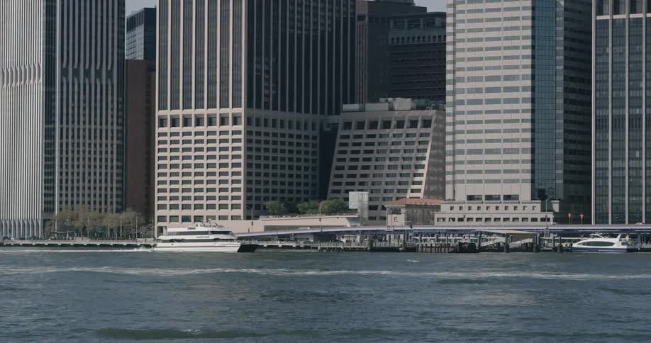 A ferry boat sailing in the river near the city