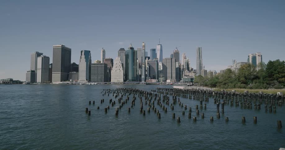 Hundreds of small pillars protruding from the water just off a rocky shore