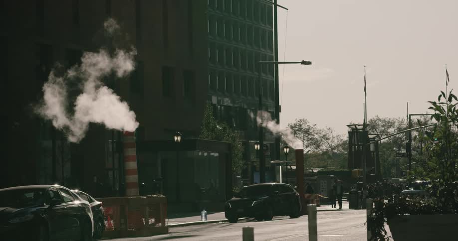Cars driving down a street in a city