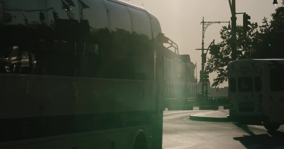 Buses drive down a city street