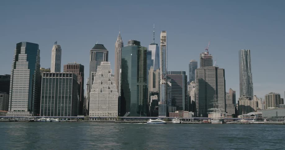 Skyline view of boats on the water in front of a downtown area