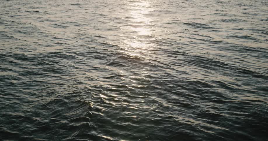 Water waves move with sun shining on it