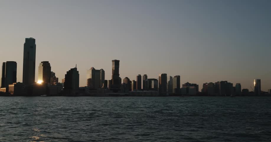 Skyline of the city with tall buildings and skyscrapers next to the at sunset