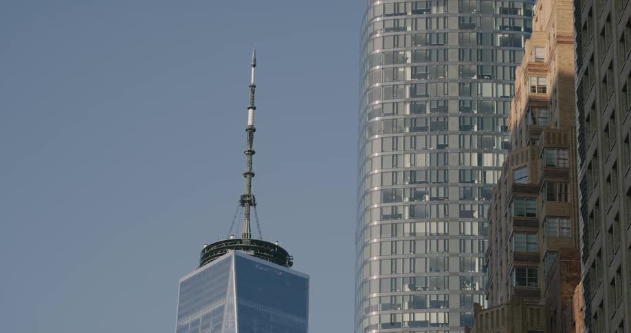 Spire and observation tower behind and next to skyscrapers