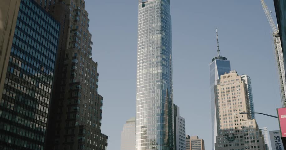 A tall skyscraper in a metropolis during the day