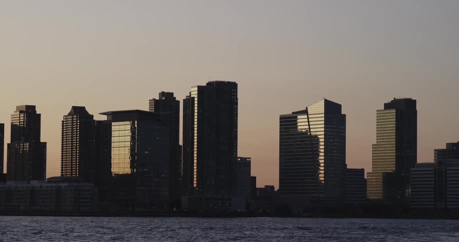 Tall buildings sit by the river