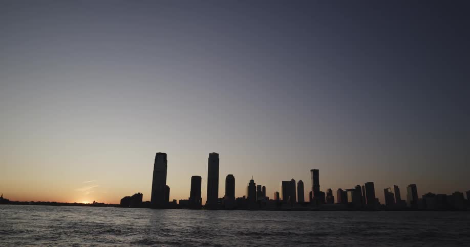The sun is setting on the large city