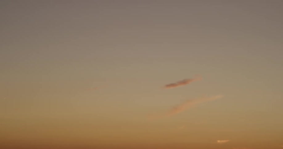 Orange sky with a few clouds in a clear sky