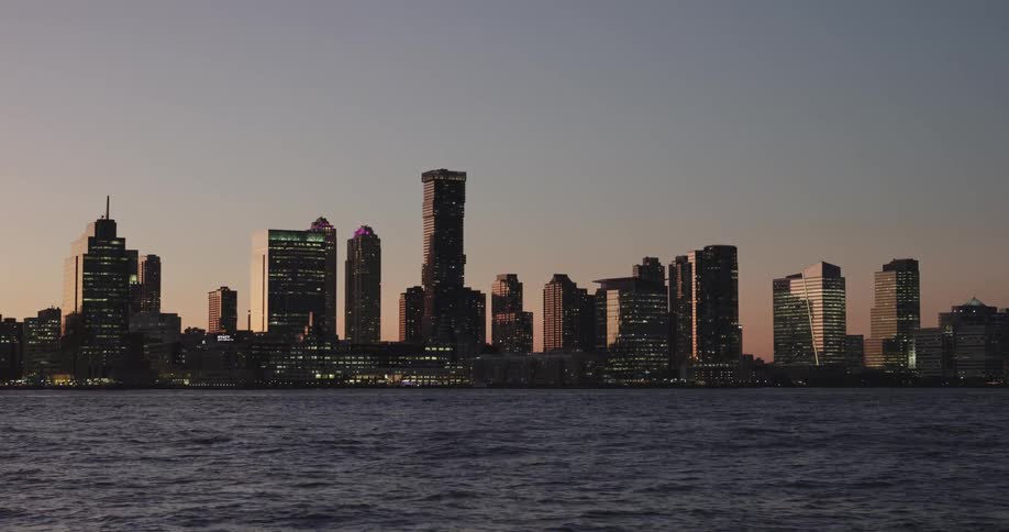 Skyline of a waterfront city at sunset