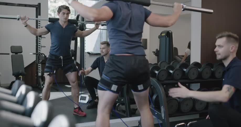 Man exercise under physical therapists watchful eye