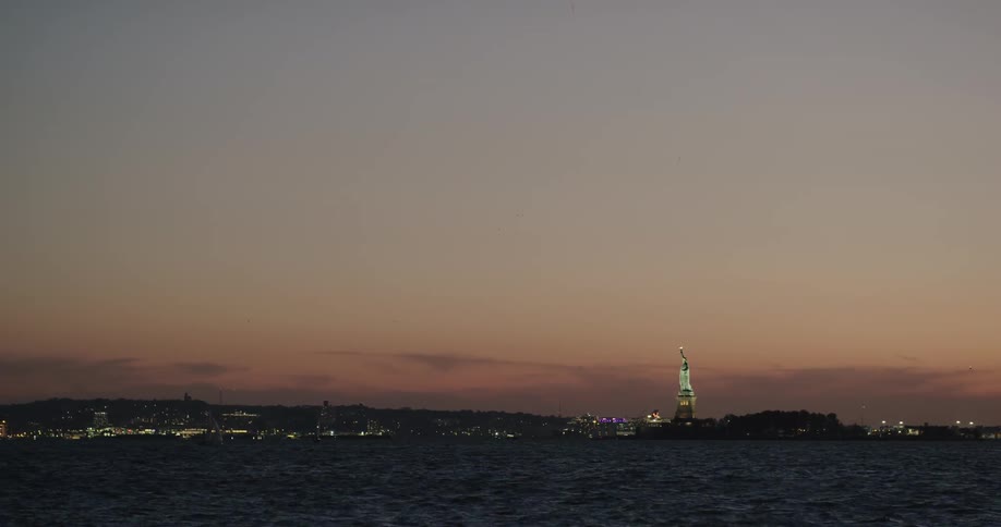 Skyline view of the statue of liberty at night