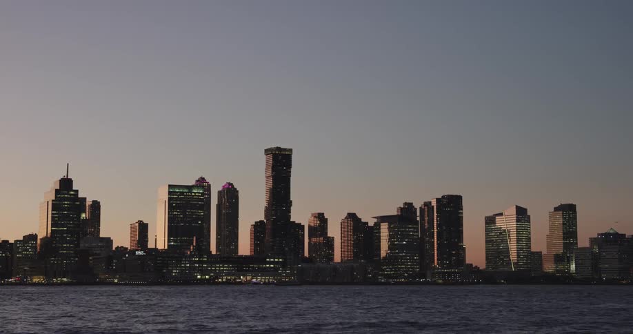 Landscape view of the water and a downtown area in the evening