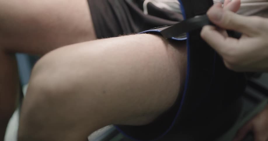 A therapist put strap on the patient leg
