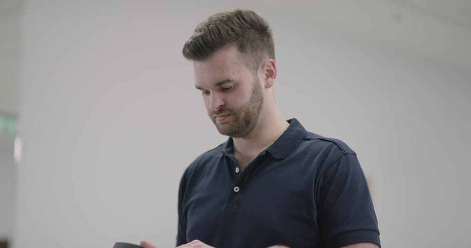 A person lies with his knee in a brace while a man looks at data on a machine