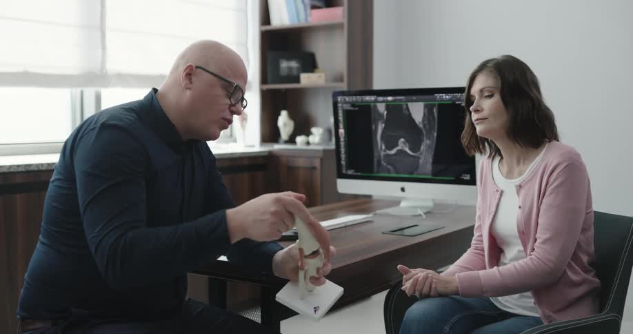 Doctor explaining how ankle works to the female patient