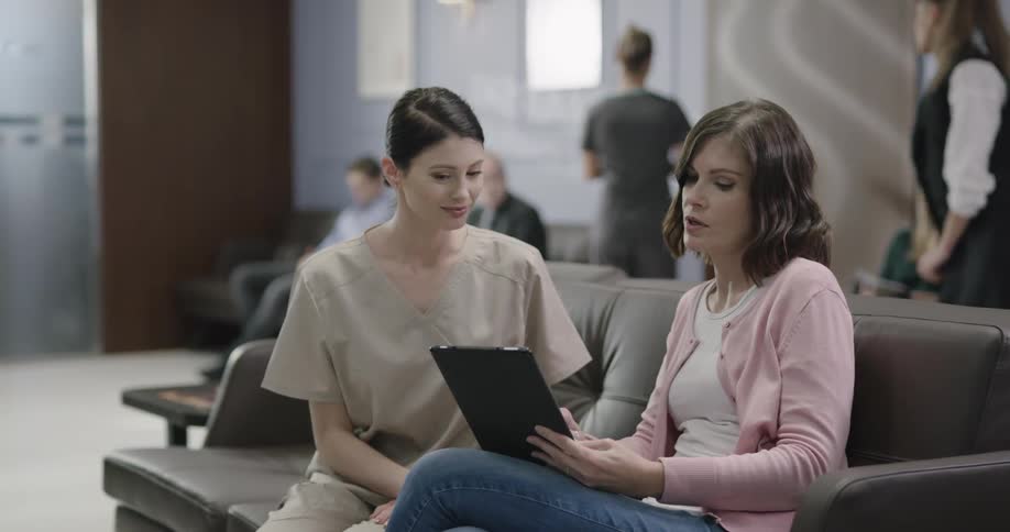 Nurse explain something to the patient at the waiting room