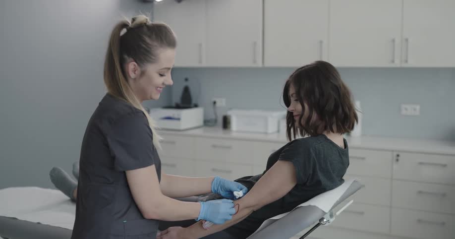 Medical professional takes blood from a woman