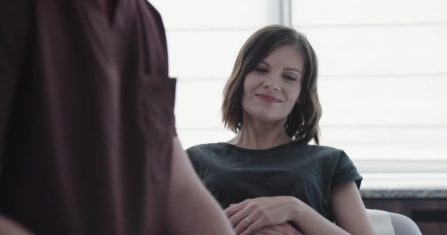 A woman is with a doctor in a room
